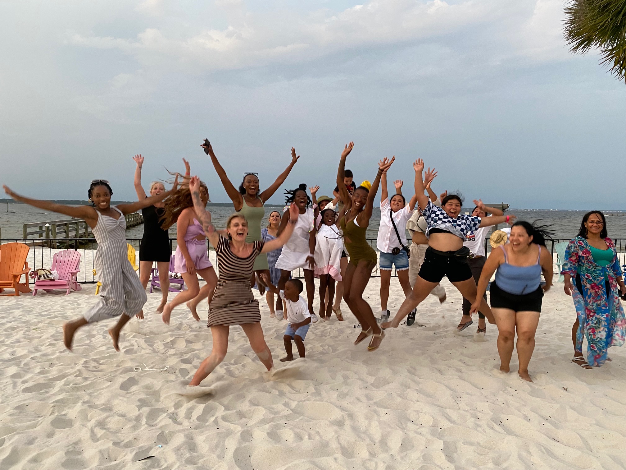 The team jumping for joy together on the beach