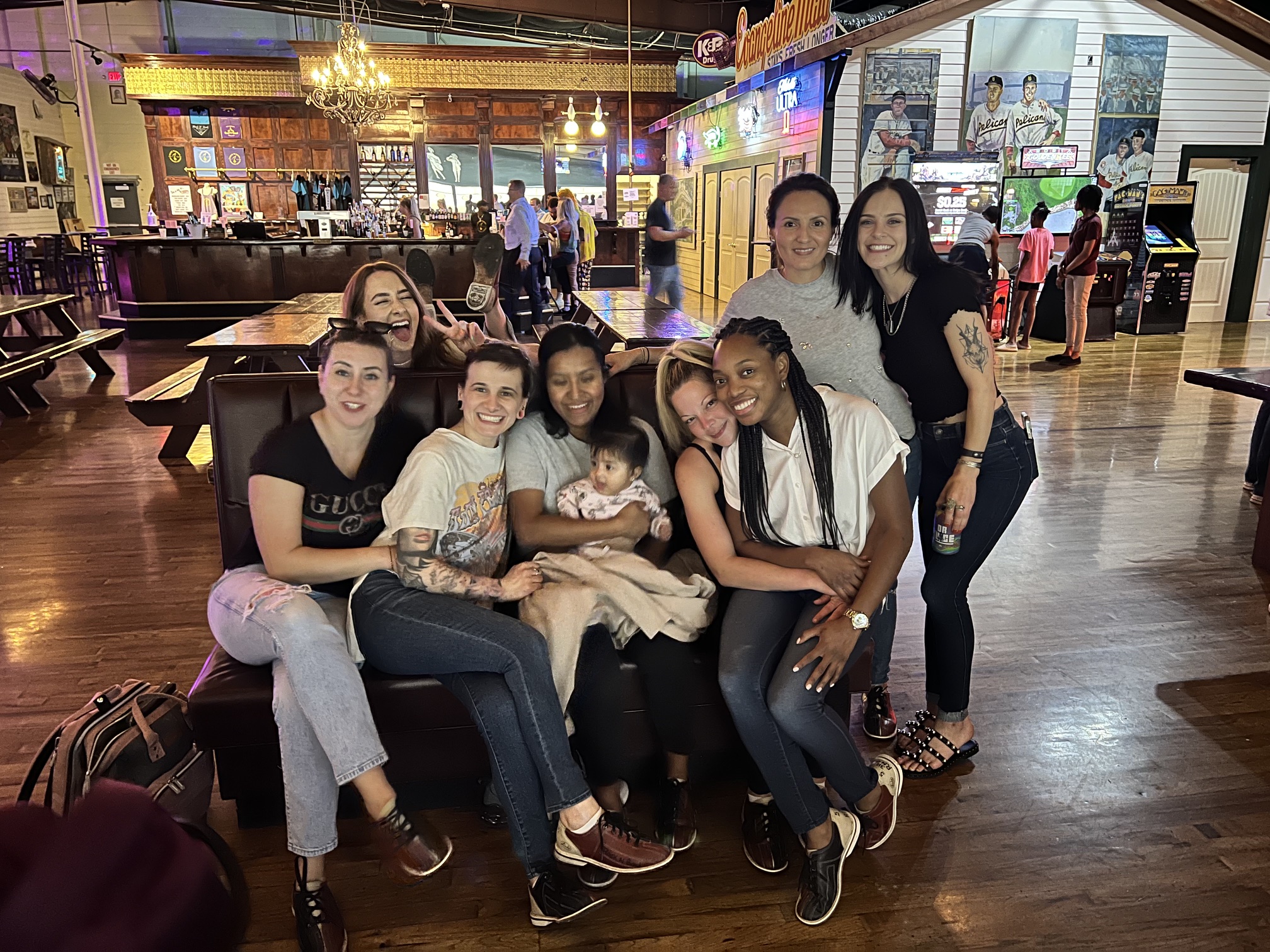 The team relaxing together on a couch at a bowling alley